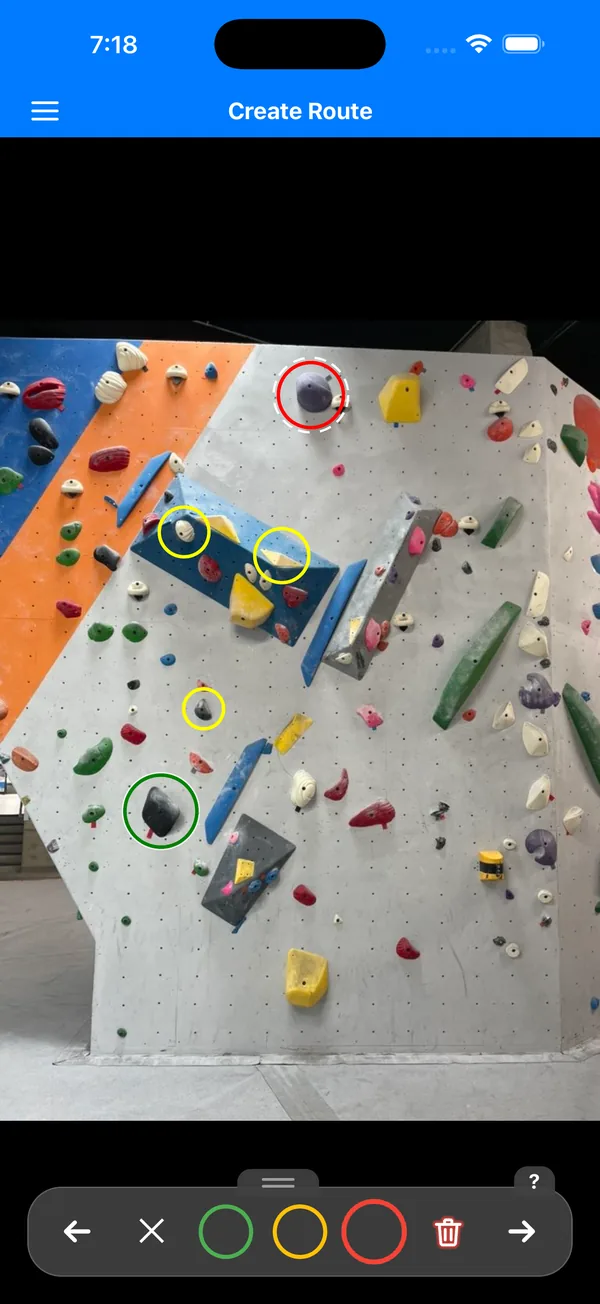 Creating a route by circling holds on a photo of a bouldering wall, with green, yellow, and red markers.